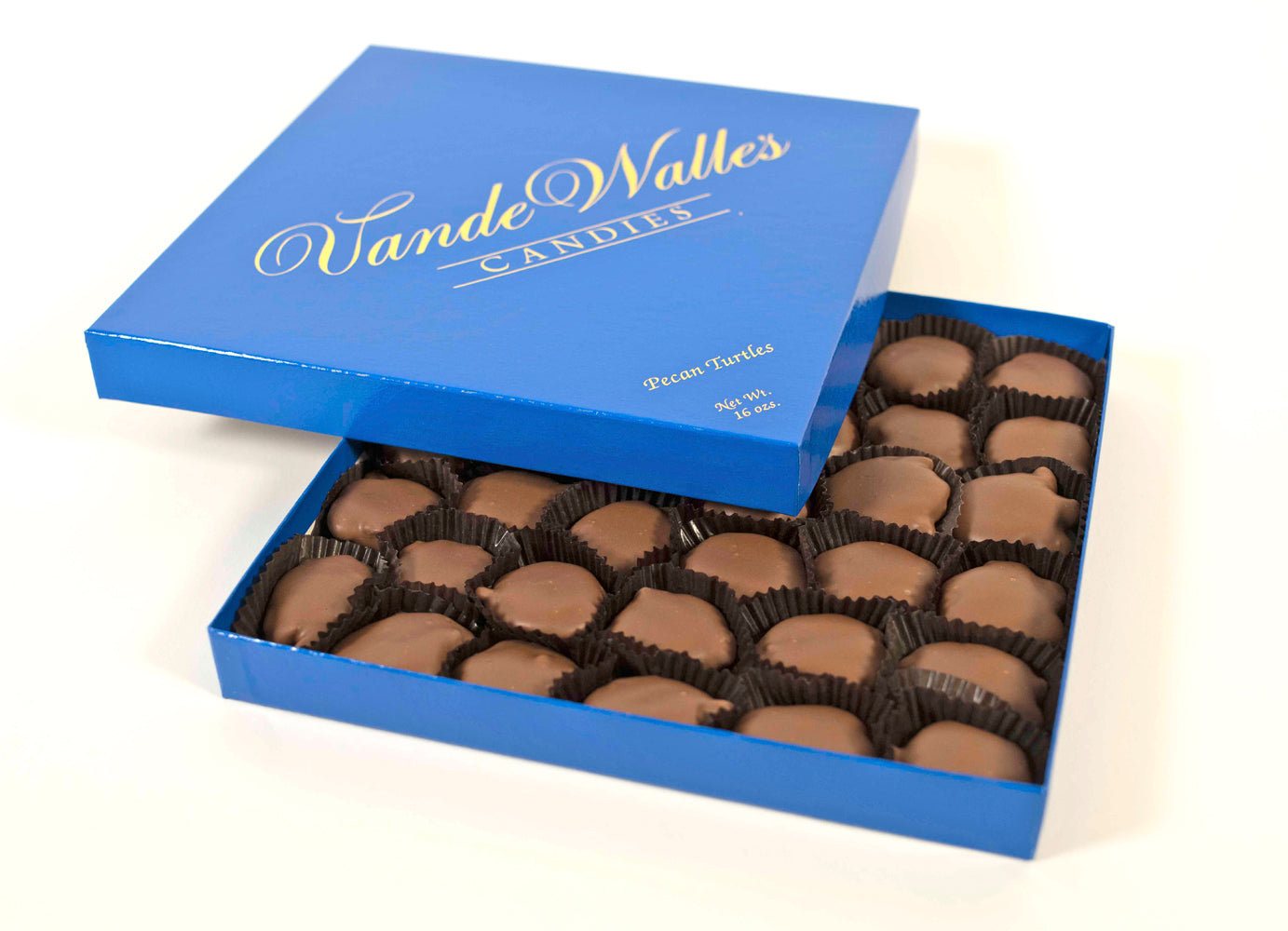 Open blue box of VandeWalle Candies pecan turtles shown on a white background